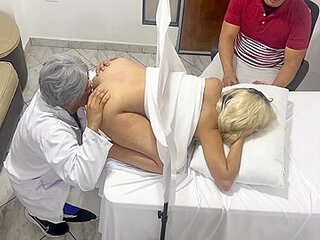 Pervert Poses As A Gynecologist Doctor To Fuck The Beautiful Wife Next To Her Dumb Husband In An Erotic Medical Consultation